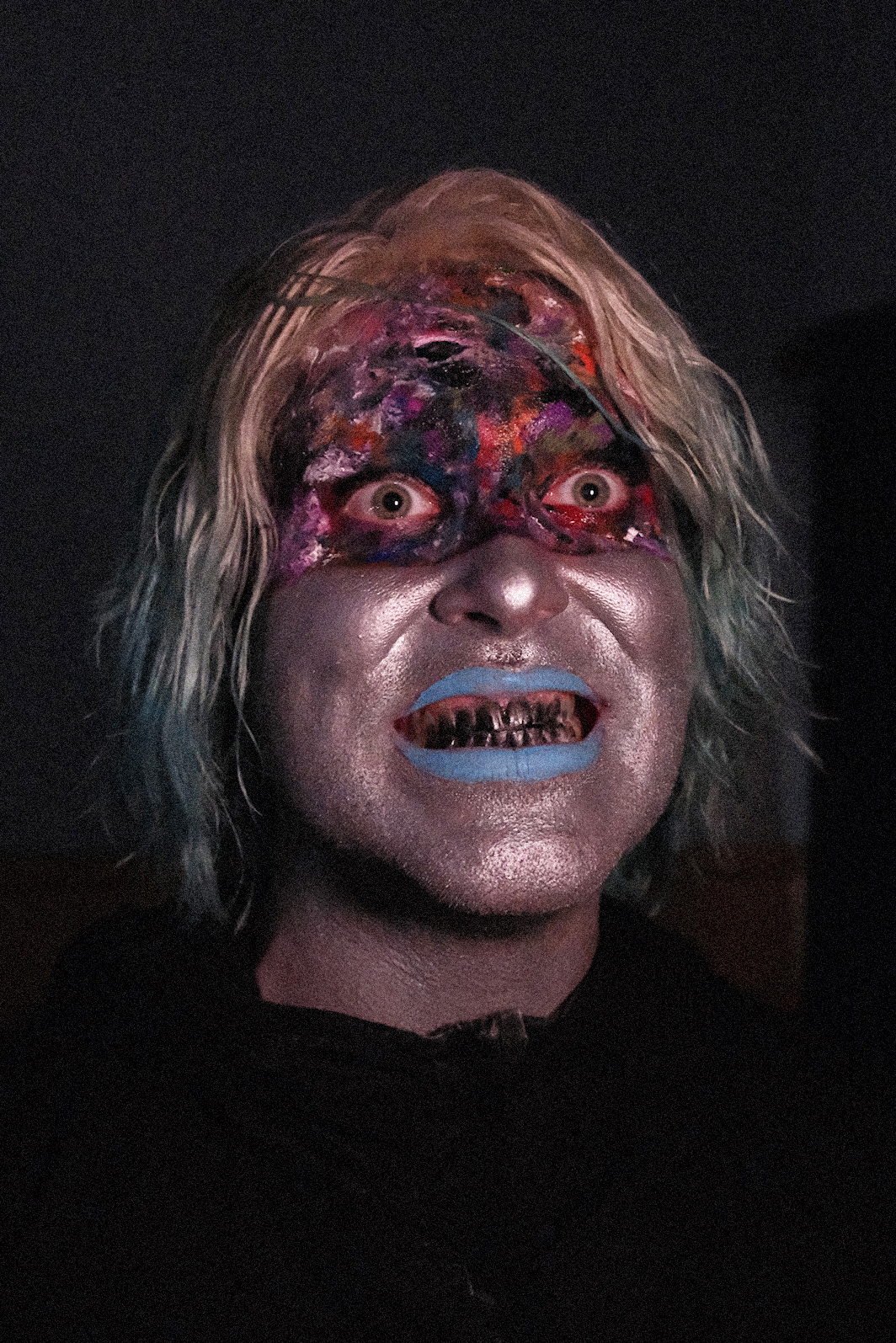 Close up portrait of Will Weisenfled with frightening makeup and blacked out teeth smiling at the camera